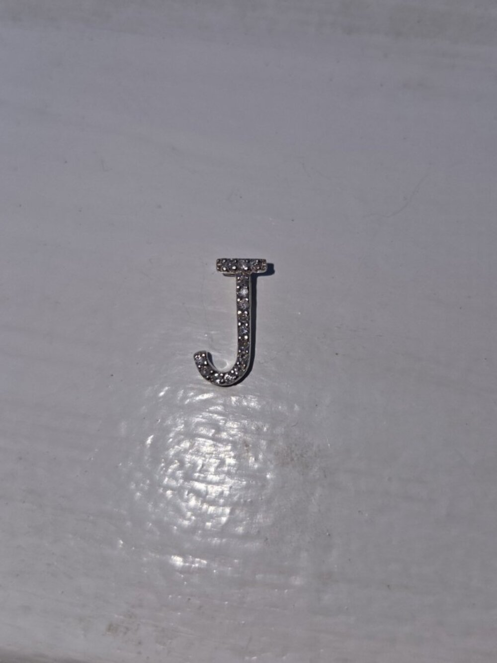 14k white gold and diamond J pendant